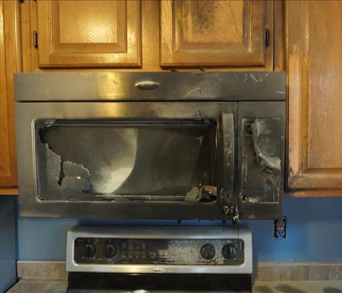 A microwave burnt to a crisp after a stove top fire