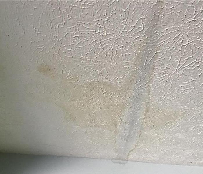 A picture of a garage ceiling with water damage of water spots.