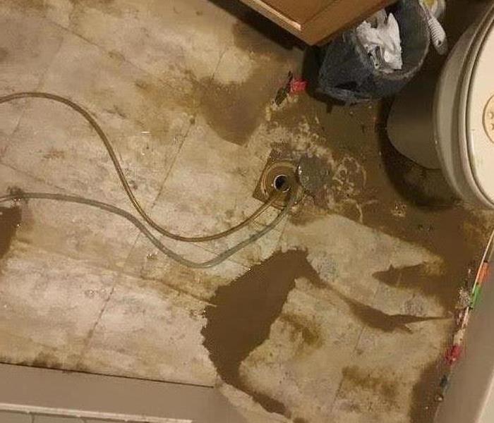 Water and mud all over the floor from the water damage 