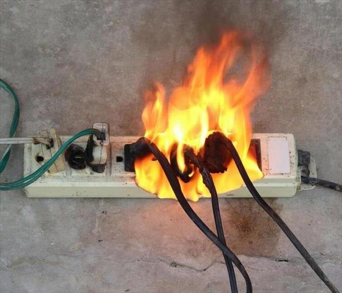 A picture of an Extension cords on fire. 