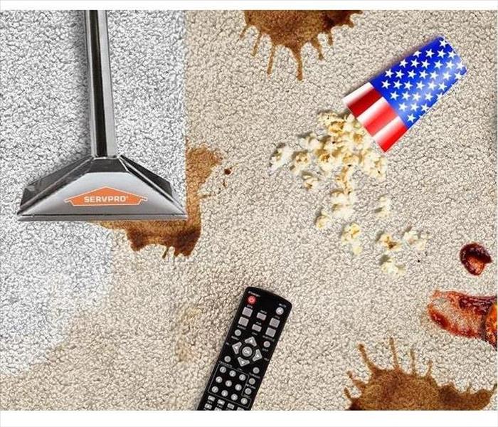 A picture of tan carpet with different types on stains with a SERVPRO machine cleaning the carpet.