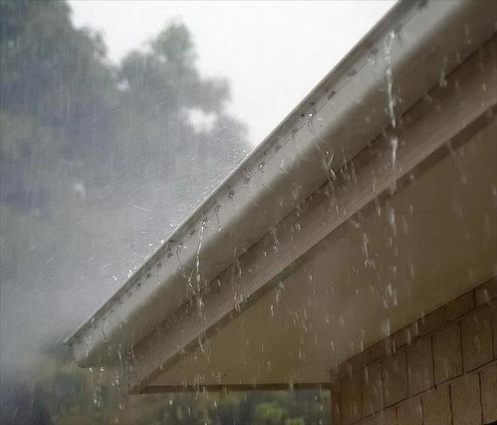 A picture of a house roof while it is raining,